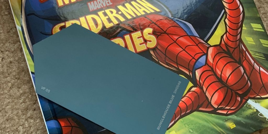 Spider-Man book and paint swatch - inspiration for the Superhero City bedroom design.